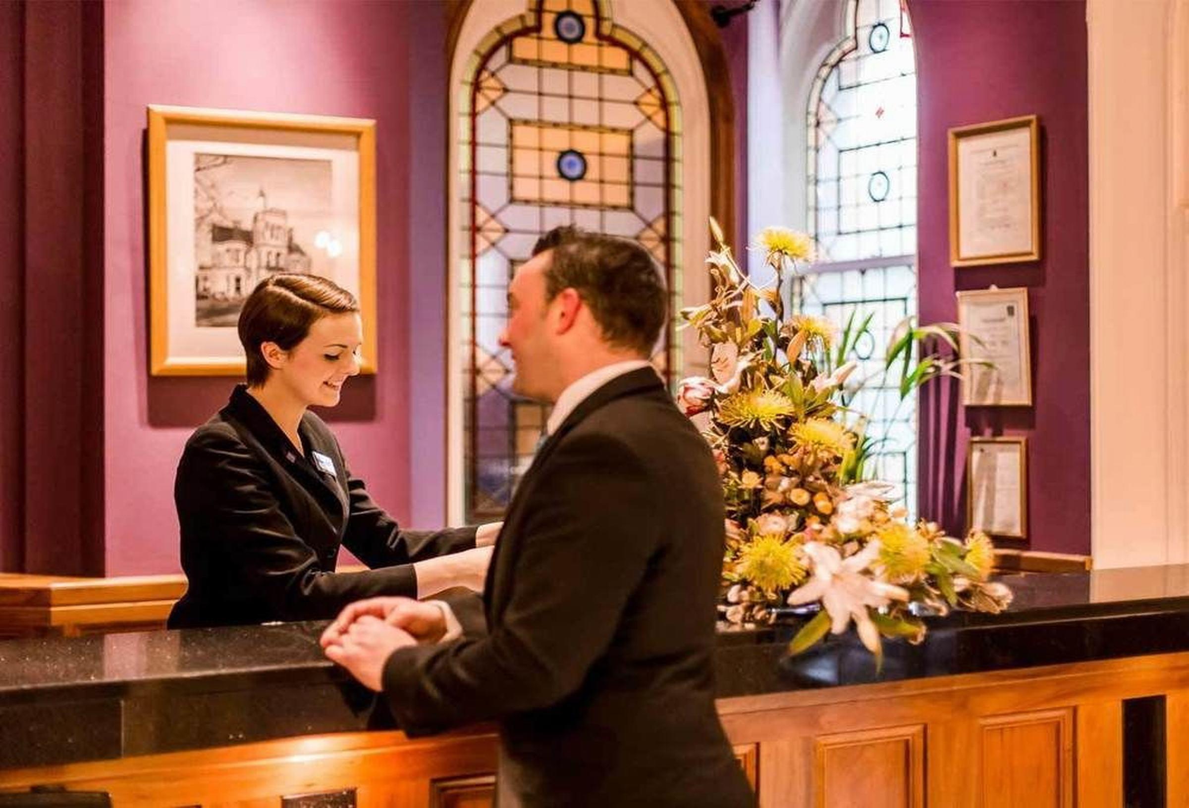 The Culloden Estate And Spa Holywood  Exterior foto A hotel receptionist at work